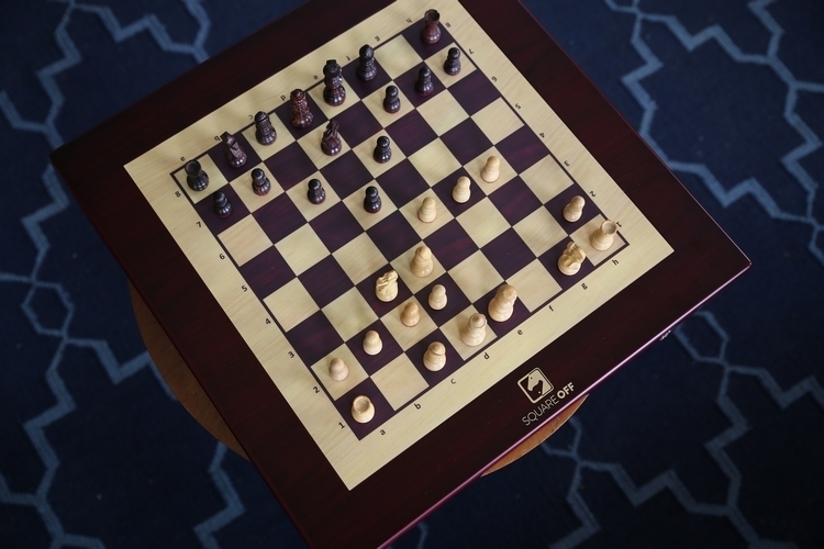 Close-up of Square Off automated chess board, which uses magnets